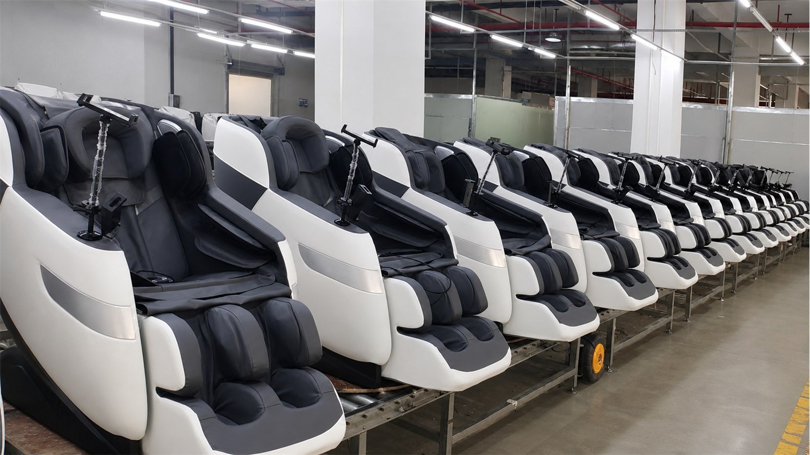 Long view of white massage chairs on the Rongqin production line